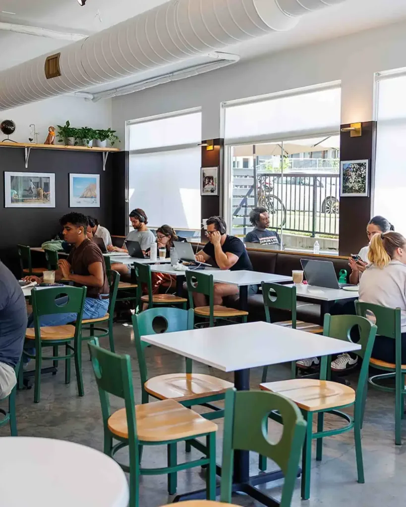 People work on laptops and enjoy coffee at the spacious All People Coffee Nashville