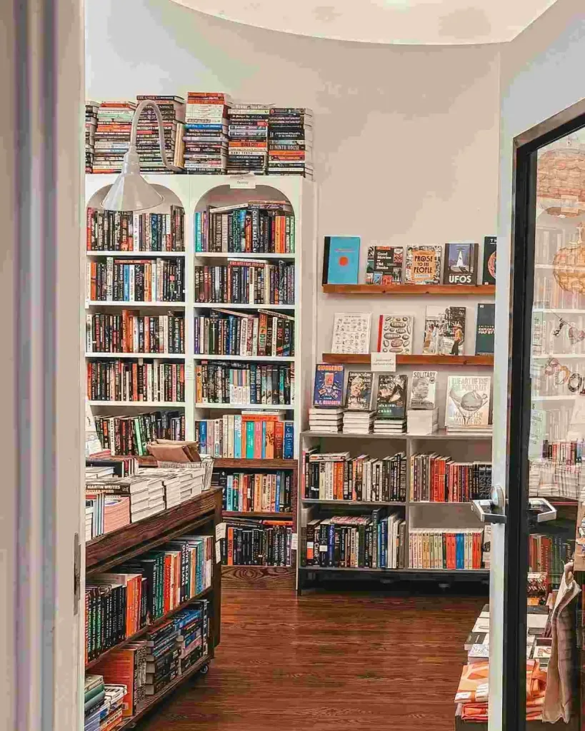 Arched shelving units filled with colorful books showcase one of the Best Bookstores in Nashville