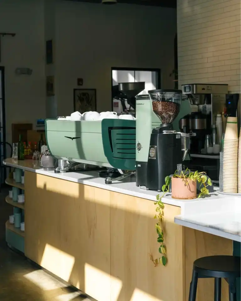 The striking green La Marzocco espresso machine on the counter at Flora and Fauna Nashville