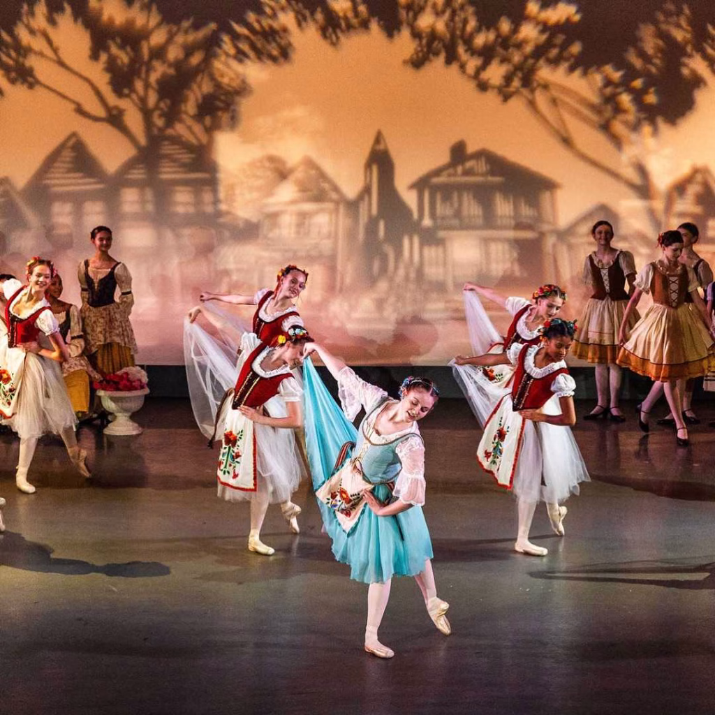 Ballet dancers performing elegant stage routine during Nashville in May event.