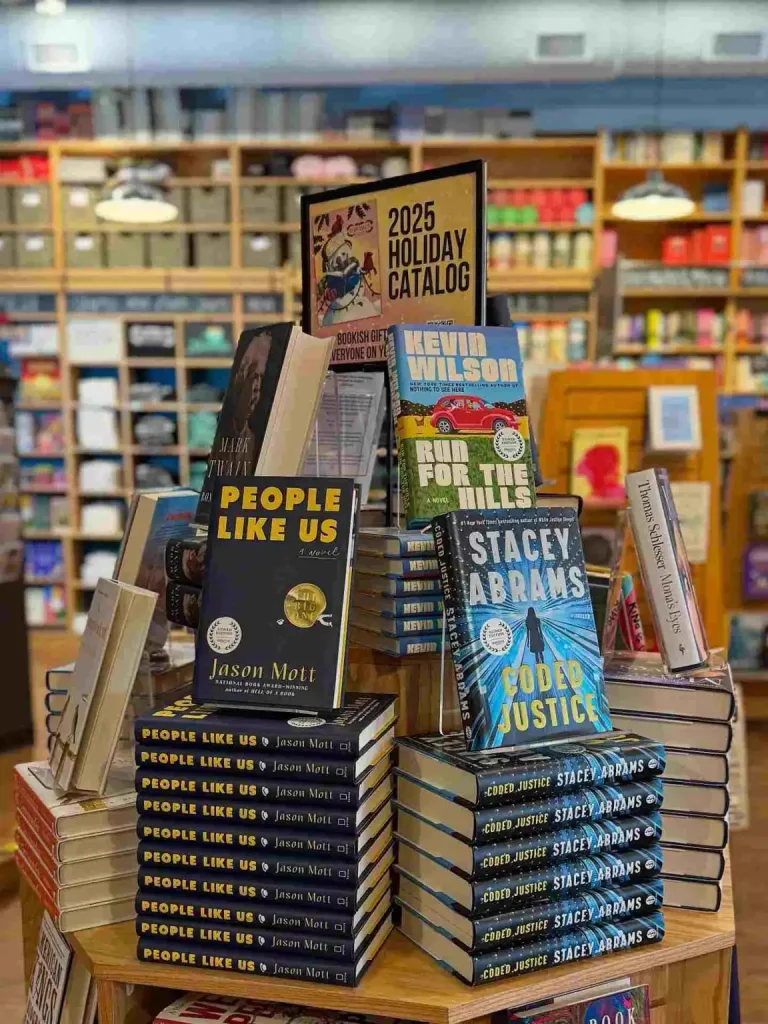 A holiday catalog display of new fiction and non-fiction books inside Parnassus Books Nashville