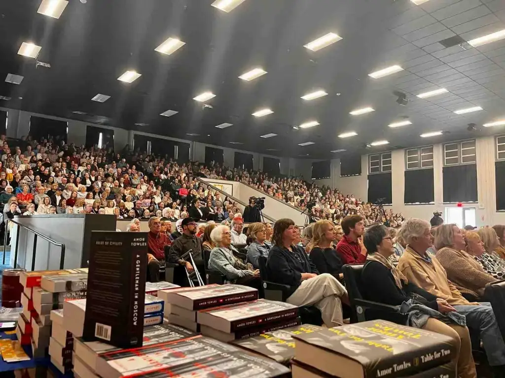 A massive crowd attends an author event at Parnassus Books Nashville in a large auditorium