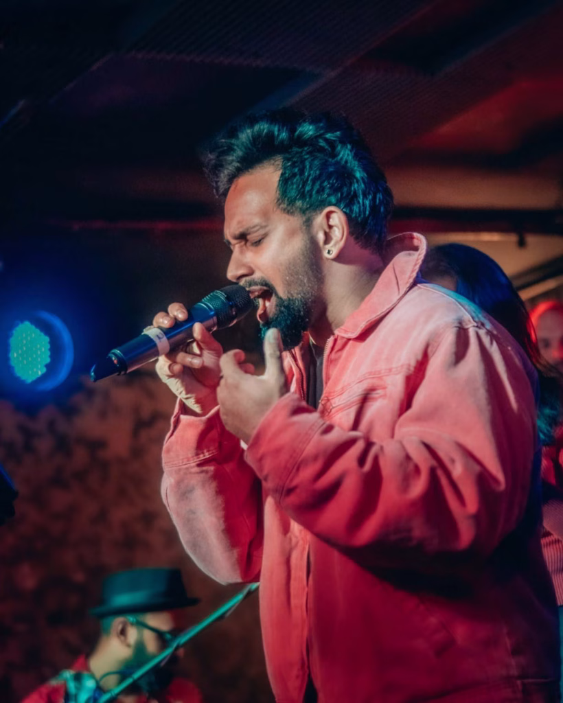 Singer performing passionately on stage, reminiscent of Nashville in June.