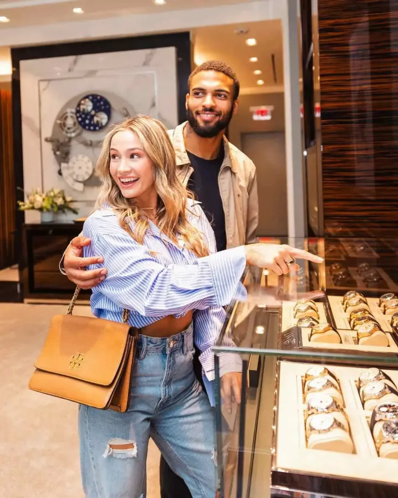 A smiling couple looks at expensive watches inside a boutique at the Mall at Green Hills Nashville Guide