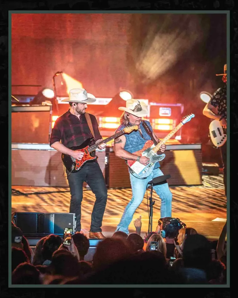 Two country guitarists in cowboy hats performing live, one of the unique things you can only do in Nashville.