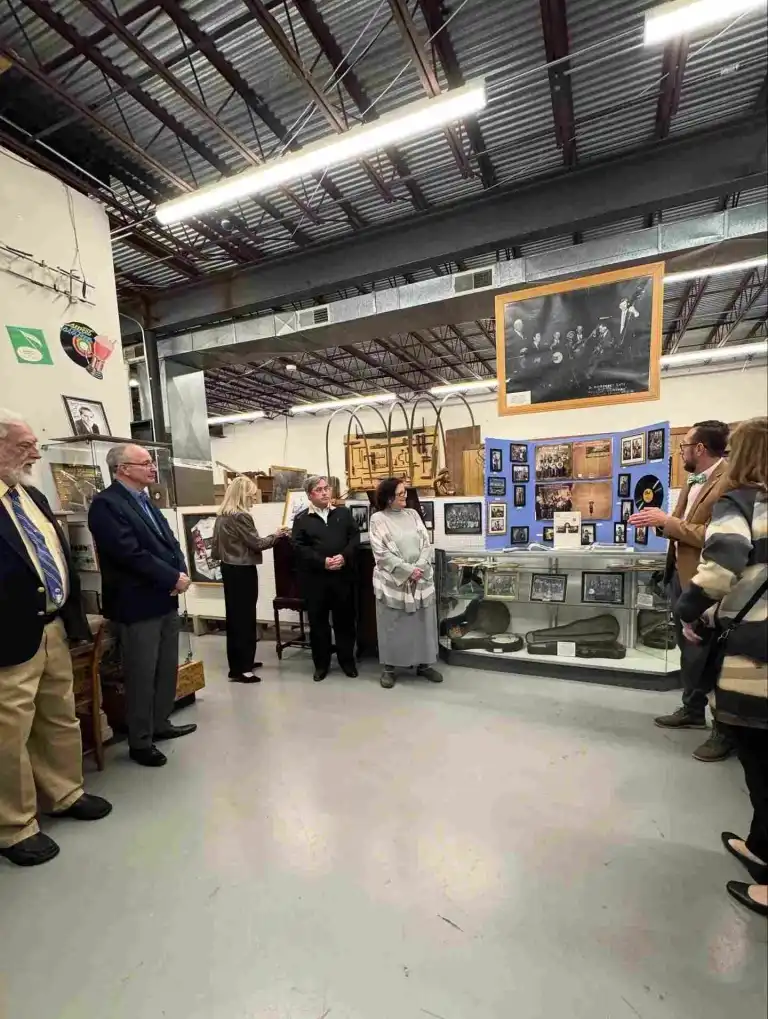 Adults gather around a historical exhibit display, learning about Tennessee history at the State Museum Nashville