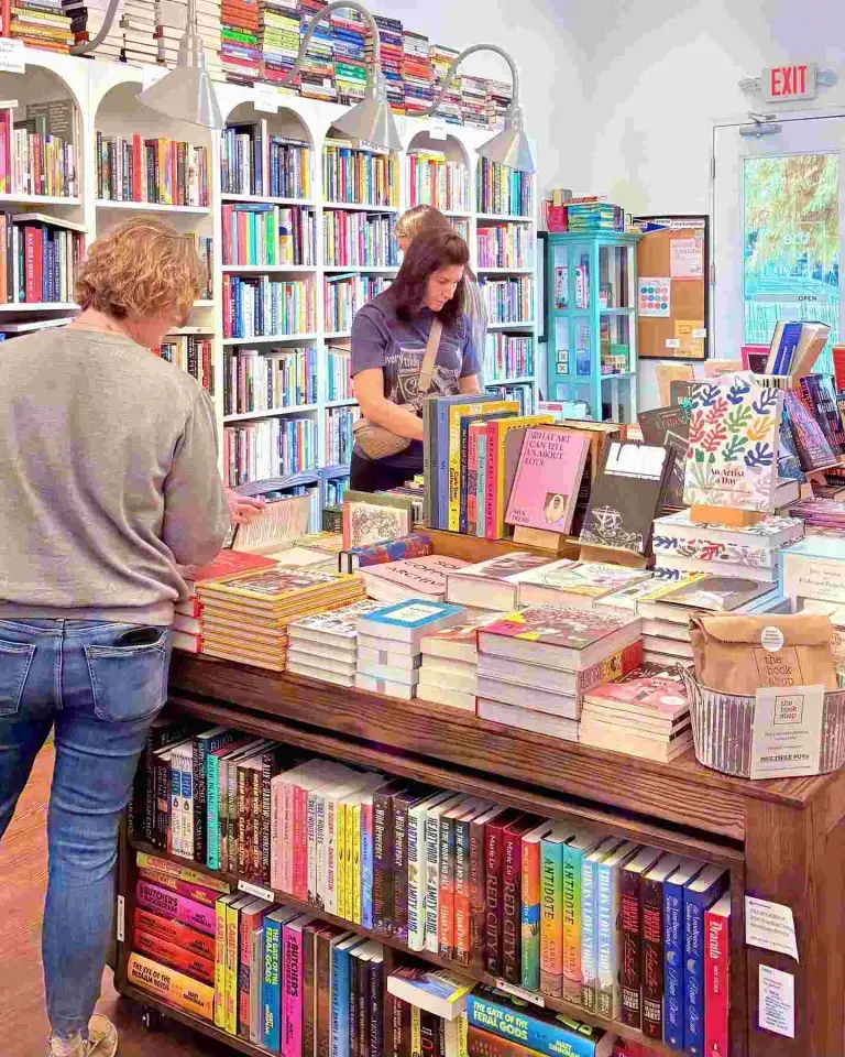 Customers browse the display tables and full bookshelves inside the welcoming space of The Bookshop Nashville