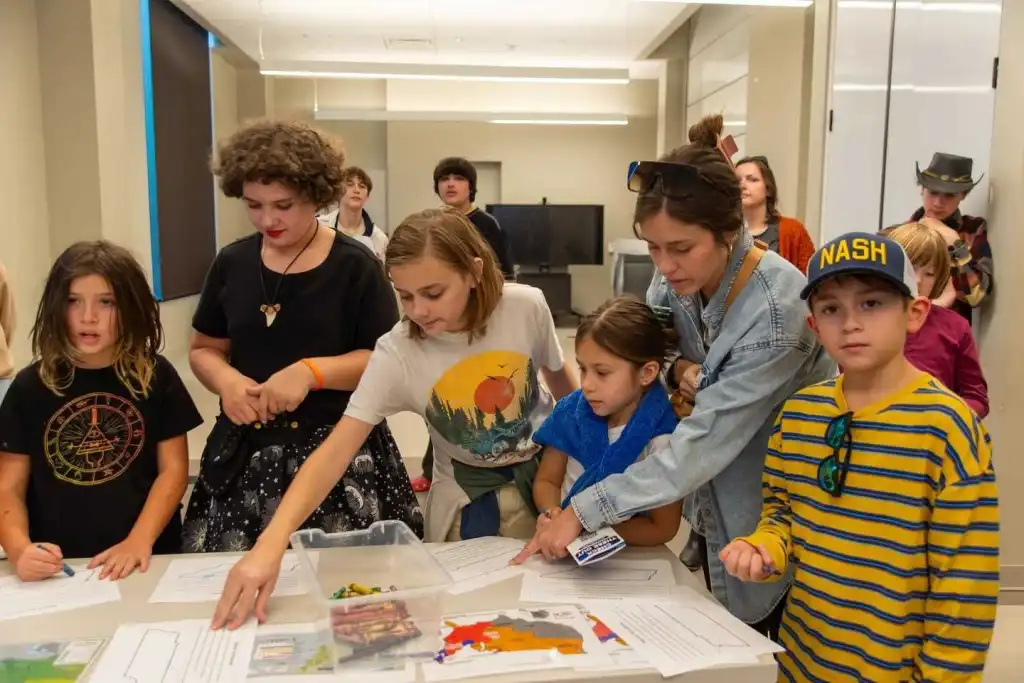 Children and adults participate in a hands-on activity at the Tennessee State Museum Nashville.