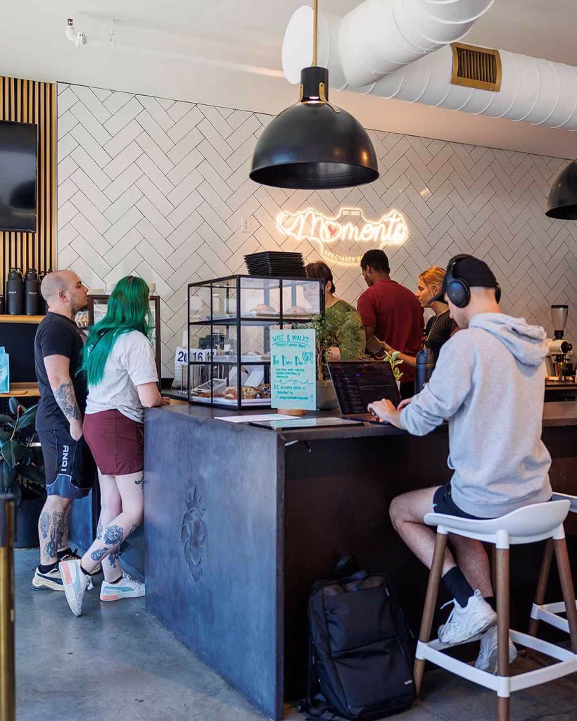 The coffee bar and neon sign are the central focus of All People Coffee Nashville.
