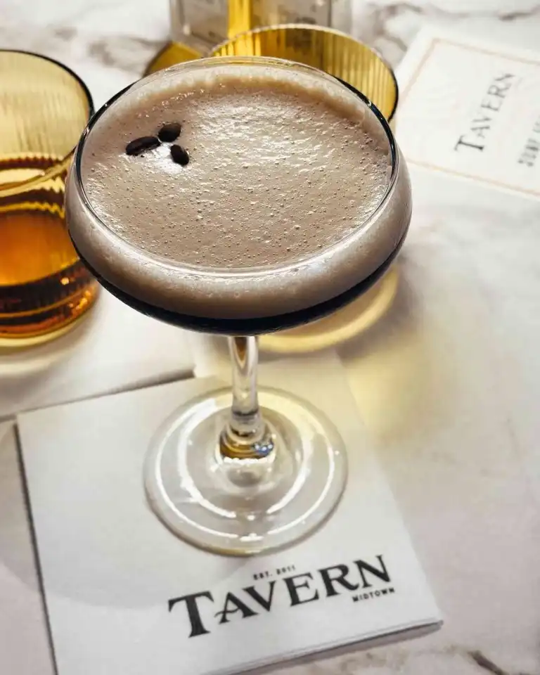 A foamy espresso martini garnished with coffee beans, a sophisticated offering near Yeast Nashville