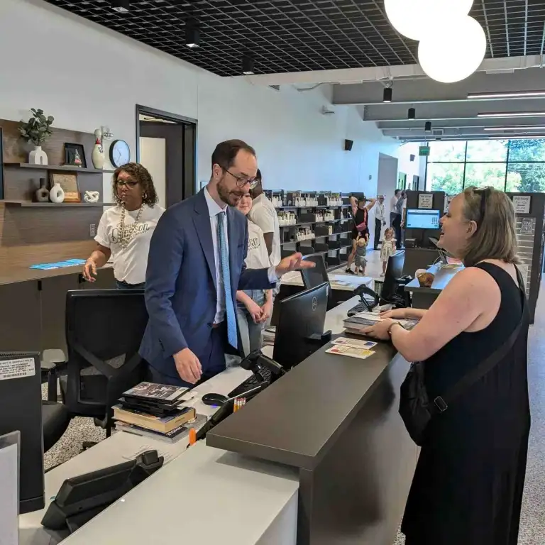 Patrons interacting with staff at the checkout desk of the downtown Nashville public library