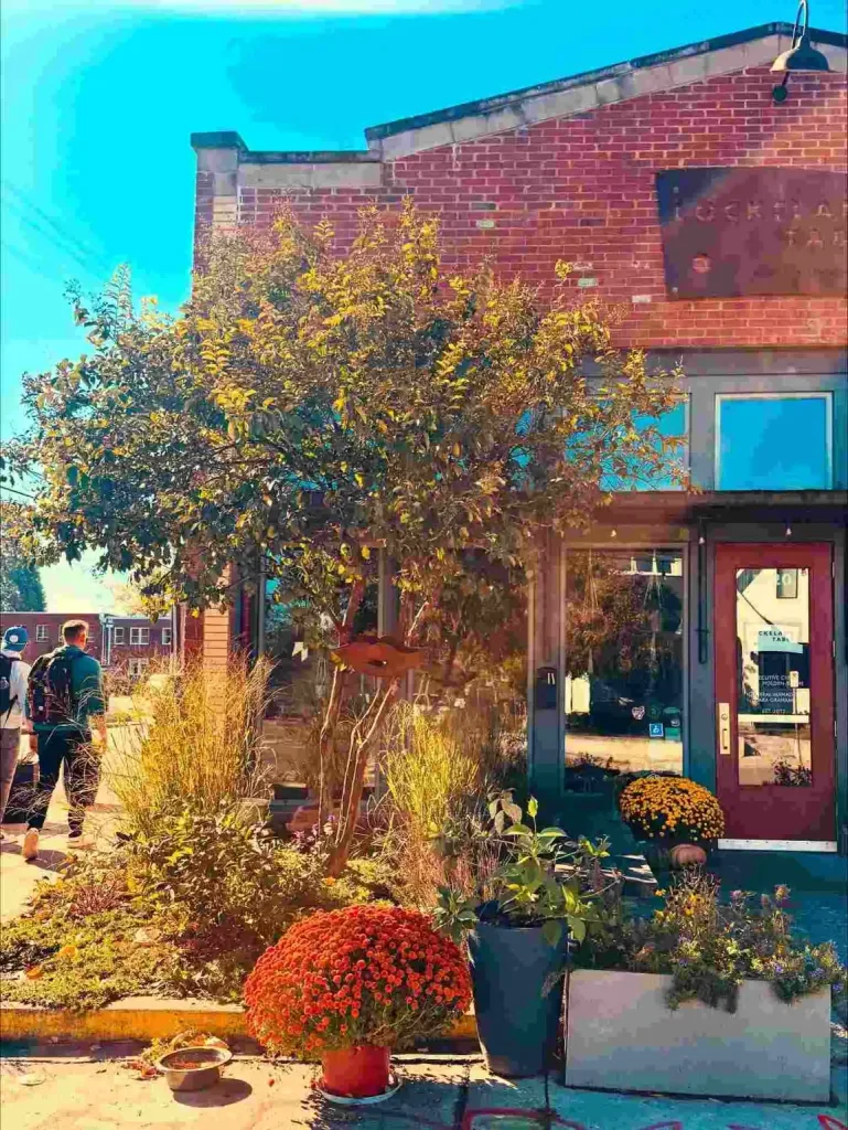 East Nashville Summer Bucket List Guide The brick exterior and flower-filled entrance of Lockeland Table, a perfect stop on the East Nashville Summer Bucket List.